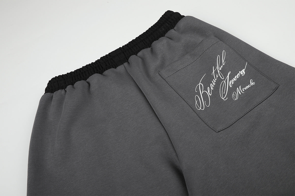 Pantalon de survêtement large à inscription et ceinture contrastante