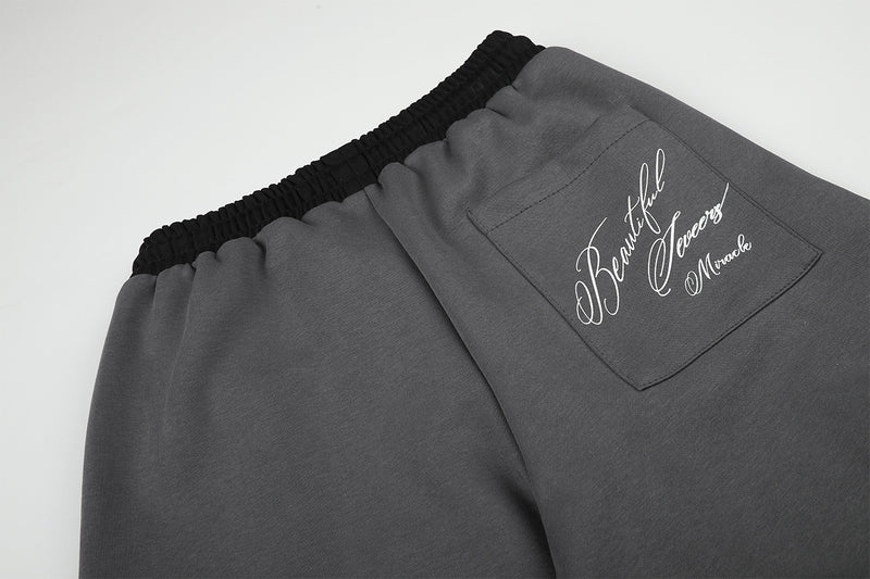 Pantalon de survêtement large à inscription et ceinture contrastante