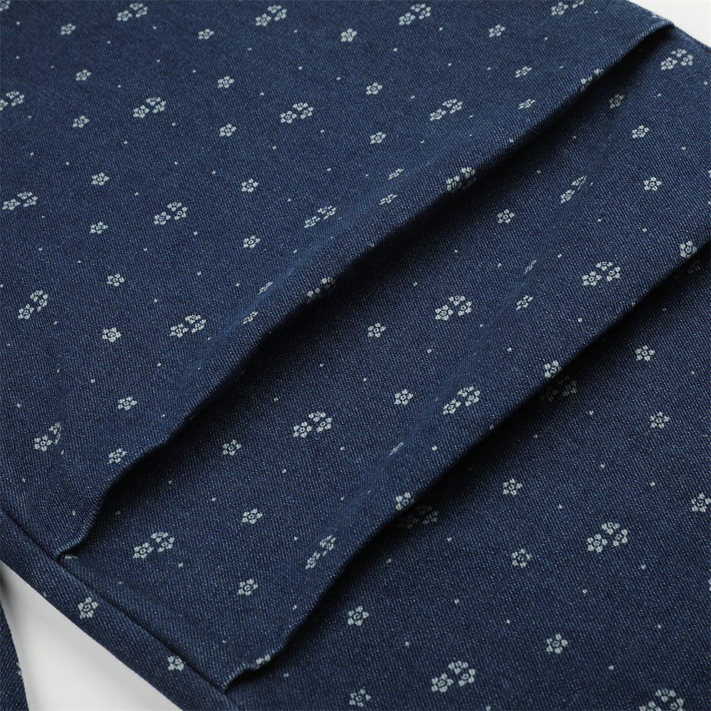 Close-up of floral print denim leg with seam detail and folded fabric