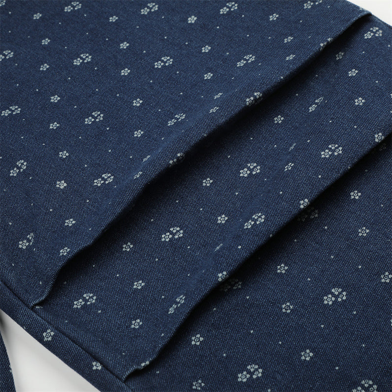 Close-up of floral print denim leg with seam detail and folded fabric