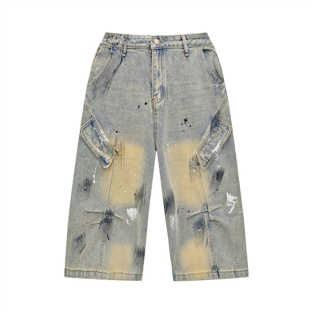 Men's hand-painted splatter distressed cargo denim shorts in acid wash light blue with paint smear detailing and oversized si