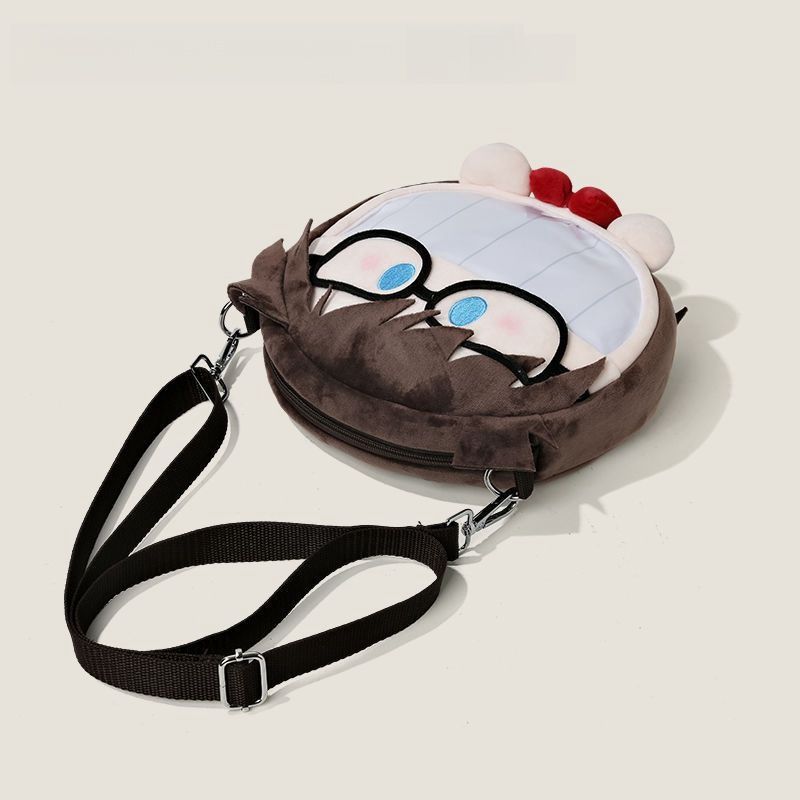 The Seakoff Detective Conan Edogawa Conan Plush Shoulder Bag features a delightful cartoon face with glasses, decorative red and white pom-poms, and includes a transparent mouth pocket. It is brown with a black adjustable strap and zip closure.