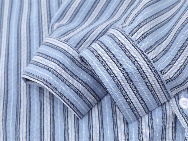 Blue striped shirt sleeve cuff close-up with buttoned cuff detail
