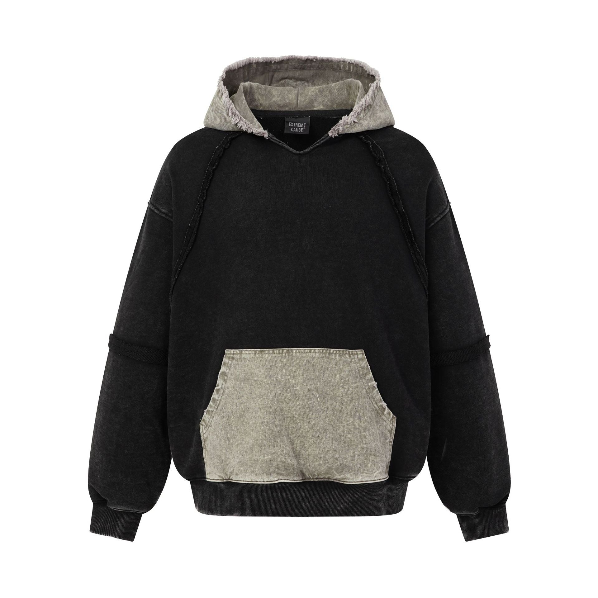 Deconstructed oversized hoodie with raw frayed edges, acid-wash finish, and contrasting colorblock kangaroo pocket in washed
