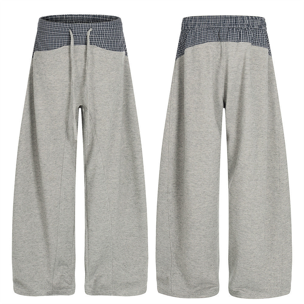 Pantalon de survêtement homme gris chiné à jambes larges, avec ceinture contrastée à carreaux bleu marine et cordon, vue de face et de dos