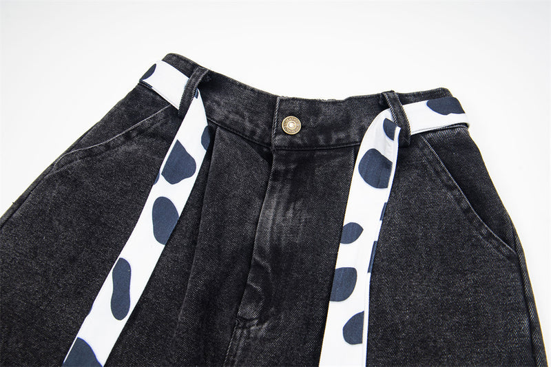 Jean noir large avec patchs chat cartoon et finitions contrastantes imprimées dalmatien