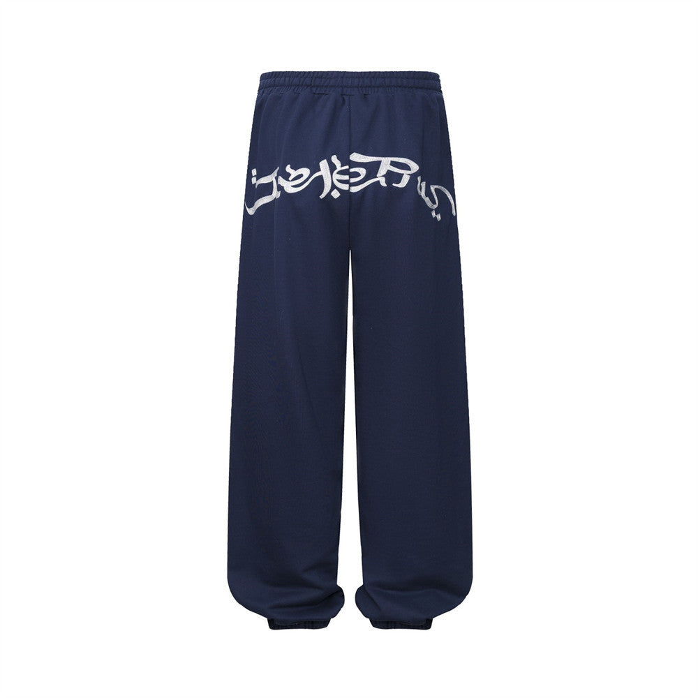 Pantalon de survêtement homme à jambes larges avec écusson brodé et imprimé graphique en écriture