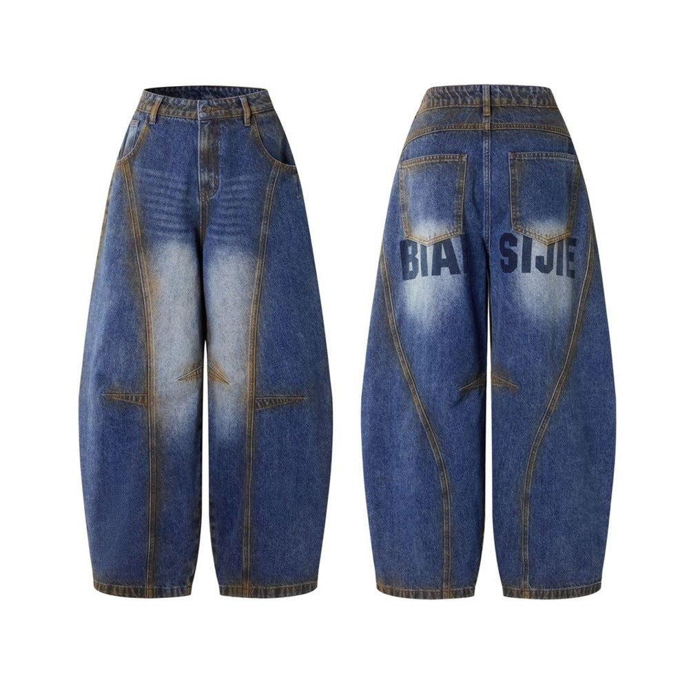 Men's baggy wide-leg deconstructed patchwork jeans in vintage blue with amber contrast stitching and letter print on back