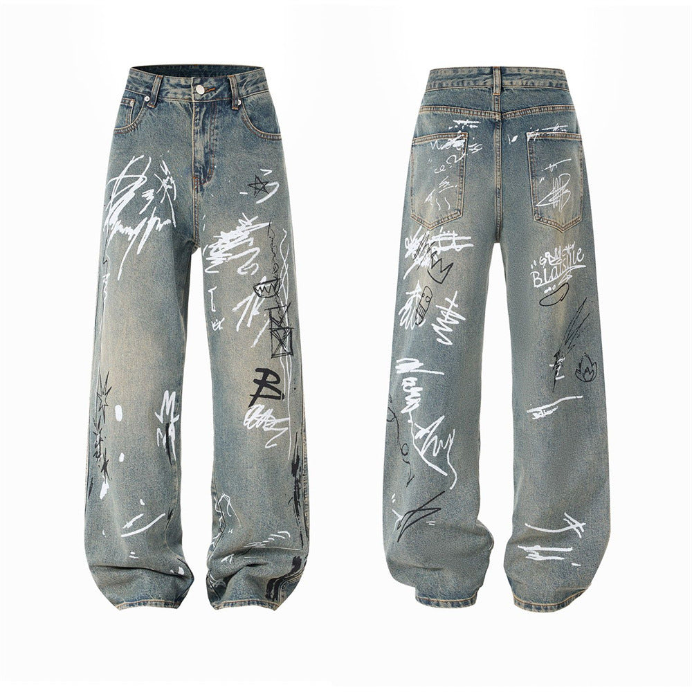Men's wide-leg straight jeans in vintage washed blue denim with all-over black and white graffiti print, front and back view