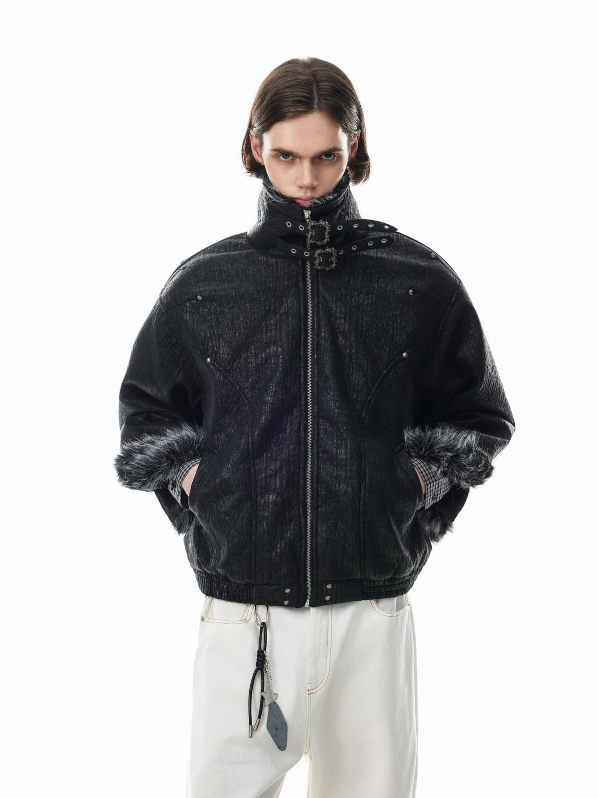 Oversized black padded bomber jacket with faux fur trim collar and cuffs, metal buckle stand collar, and silver stud rivets