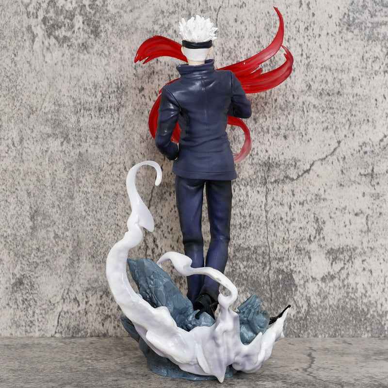 The Jujutsu Kaisen Gojo Satoru PVC Figure – 28.5 cm displays him in a dynamic battle pose, featuring white hair, a black blindfold, and dark blue attire, surrounded by swirling red energy against a gray backdrop.