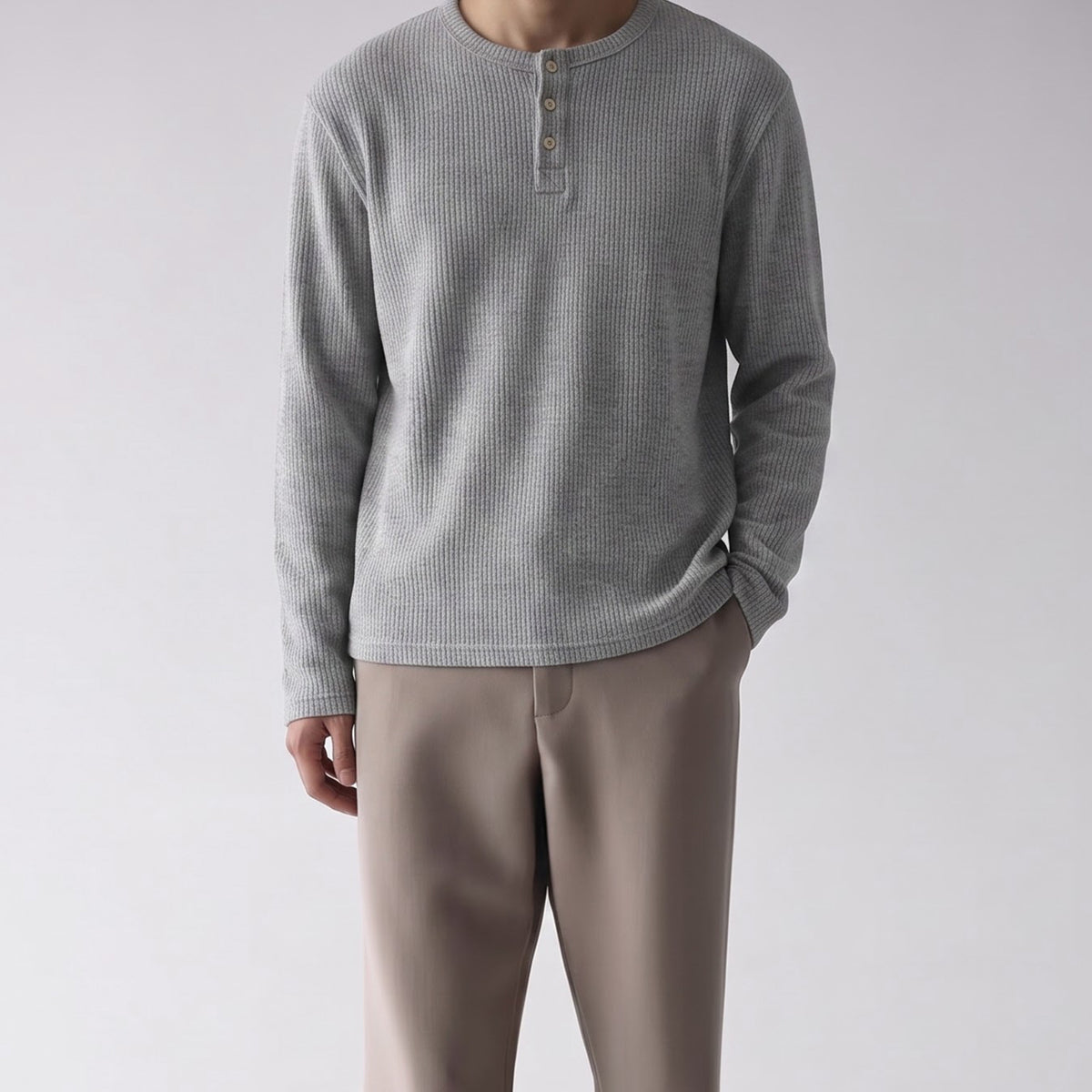 Men's ribbed Henley long-sleeve shirt in heather grey with three-button placket, worn with beige trousers
