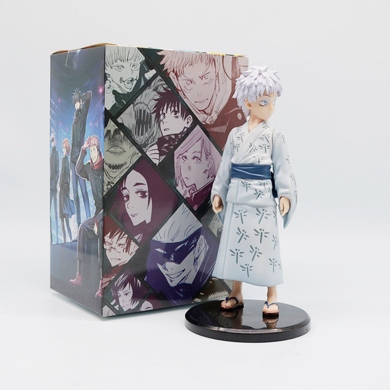 The Jujutsu Kaisen Satoru Gojo PVC Figure – 18 cm, depicts Satoru Gojo in a light blue Yukata with dark patterns, standing on a black base. It comes in a colorful box featuring various anime characters with a predominantly dark theme.