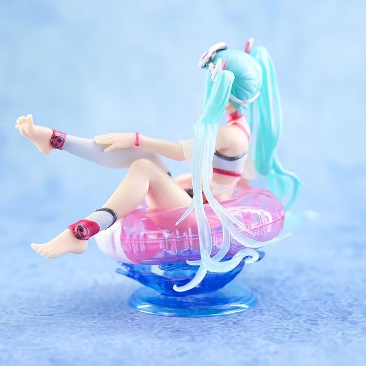 The Hatsune Miku Swimsuit with Float Ring PVC Figure features a small 11cm figure with long teal hair sitting in a translucent pink float ring. It&