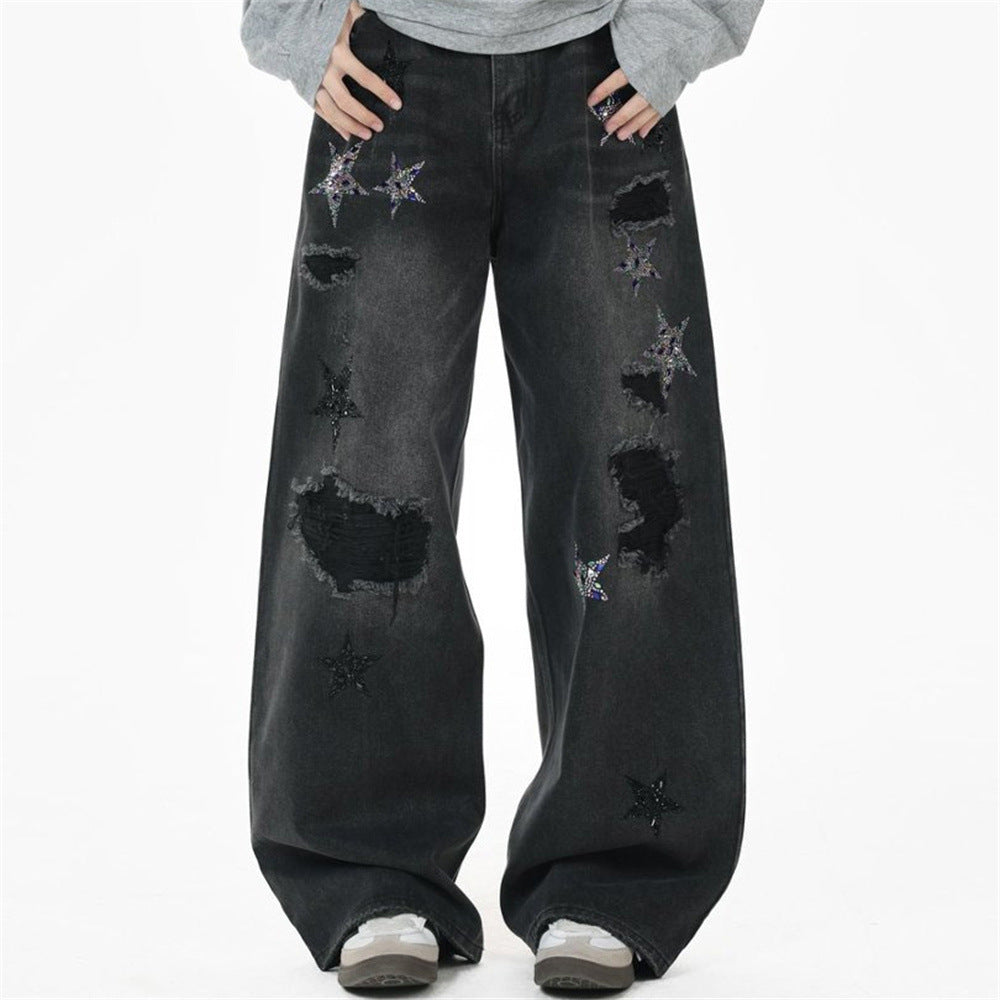 Men's ripped baggy wide-leg black denim jeans with iridescent rhinestone and matte sequin five-pointed star appliqués and lar