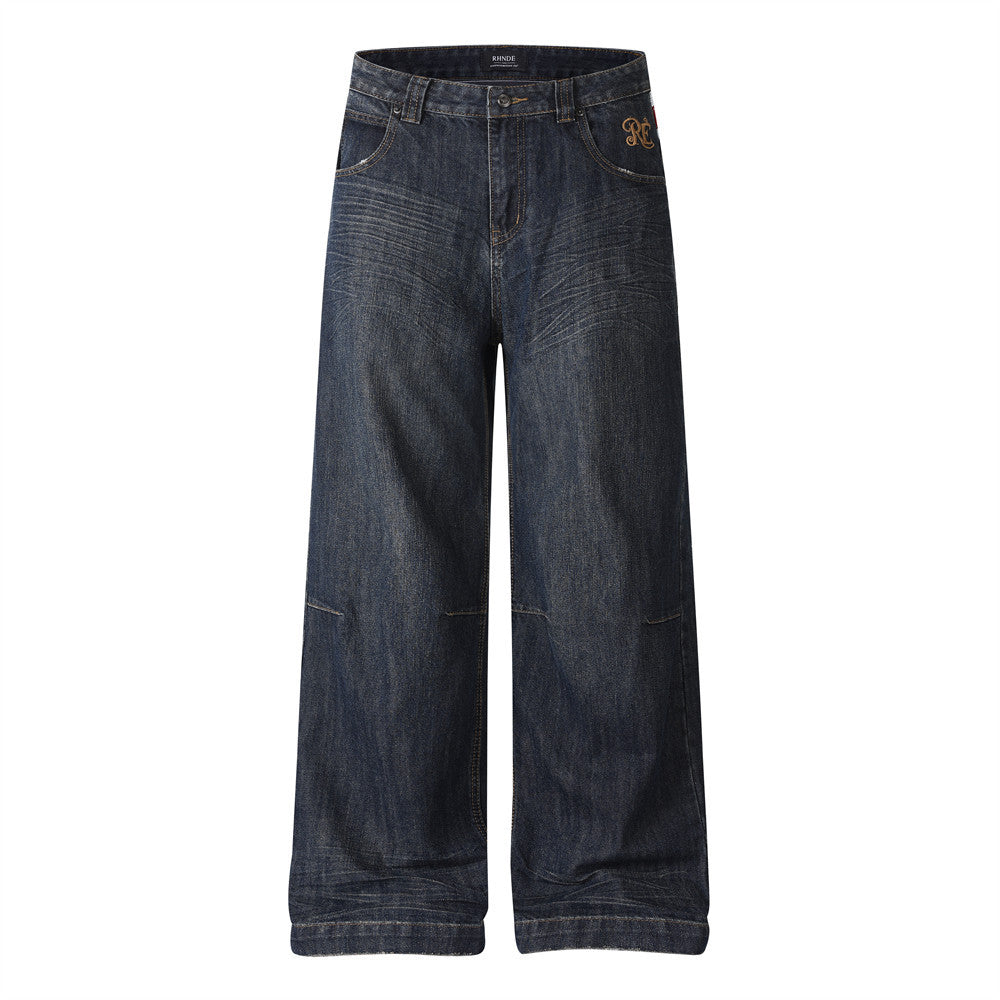 RHNDE dark indigo wide-leg jeans with Union Jack leather waistband panel and gold embroidered monogram logo, front and back v