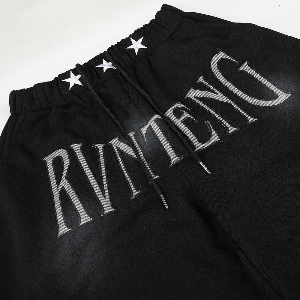 Pantalones de chándal holgados de pernera ancha con lavado efecto spray y gráfico de letras