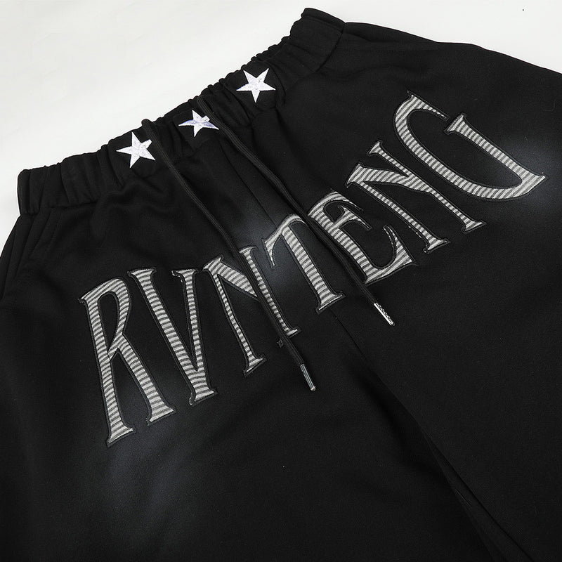 Pantalones de chándal holgados de pernera ancha con lavado efecto spray y gráfico de letras