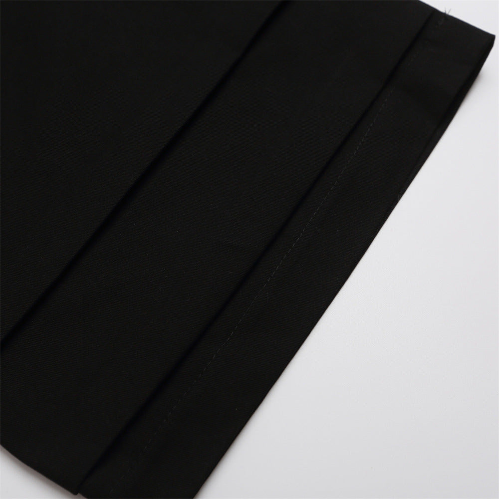 Close-up of black shorts leg hem with straight stitching and fold detail