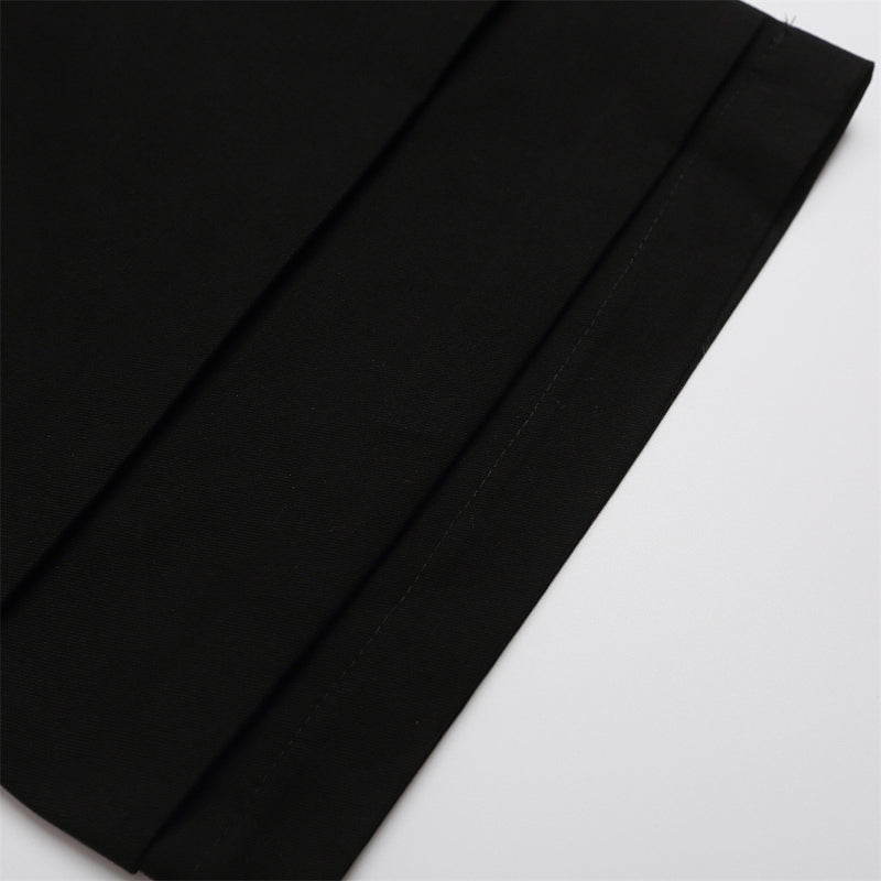 Close-up of black shorts leg hem with straight stitching and fold detail