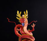 The Seakoff Red Shenron Collectible Figure – Dragon Ball Z is a 30cm, high-detail dragon statue featuring intricately sculpted red and gold scales, an open mouth, and long curving horns against a black background. Its extended tongue and whiskers reflect expert craftsmanship.