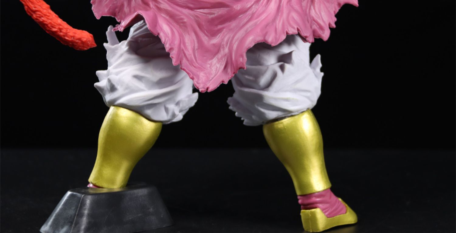 The Seakoff Super Saiyan Broly Collectible Figure from Dragon Ball Z features a pink top, white pants, shiny yellow boots, and a red tail. Standing 33cm tall on a black base with widely spaced legs, this premium action figure pops against the background.