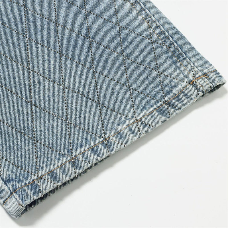 Close-up of light blue jeans hem with diamond stitch detail