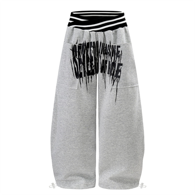 Pantalon de survêtement large à lettrage graffiti avec ceinture croisée contrastante à rayures