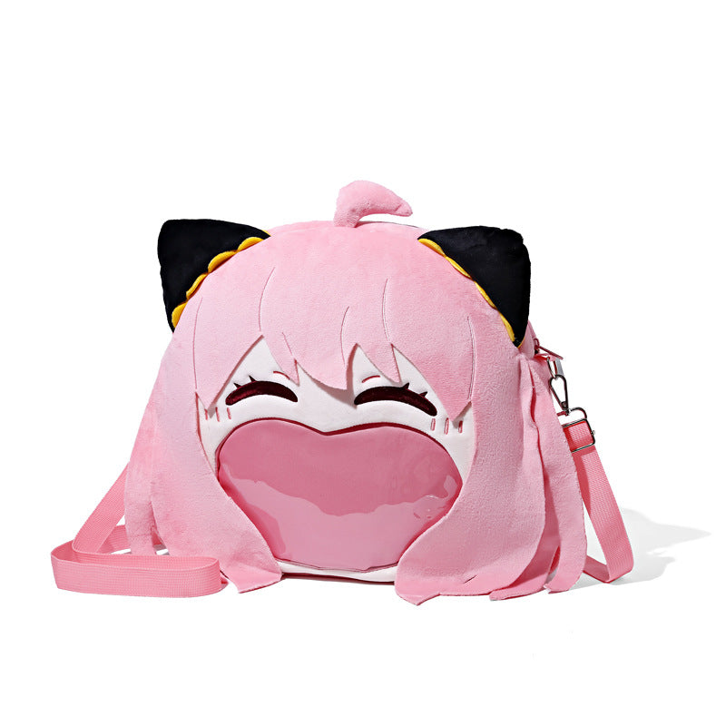 The Seakoff Spy x Family Anya Forger Plush Shoulder Bag is perfect for anime fans, featuring a cartoon character with pink hair, cat ears, and a smiling face. It includes a large heart design on the front and comes with a detachable pink strap, along with a transparent mouth pocket.