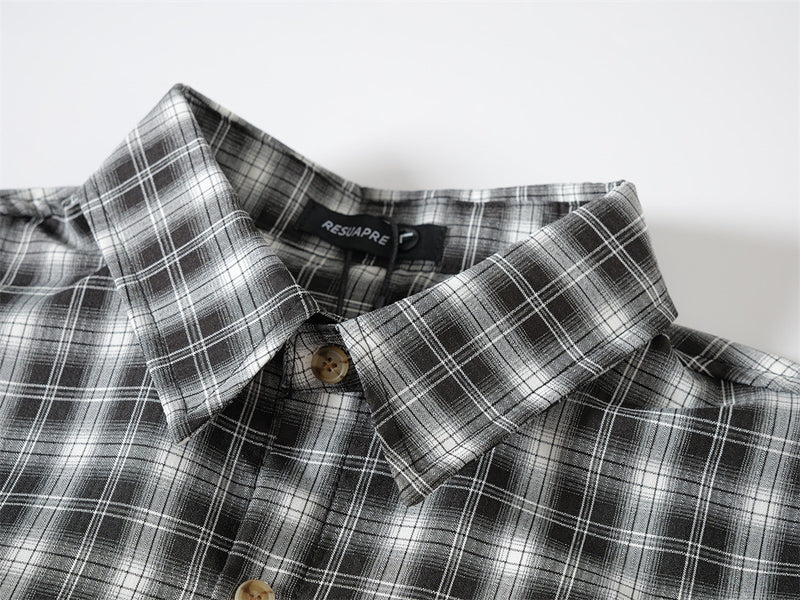 Close-up of black plaid shirt collar and top button