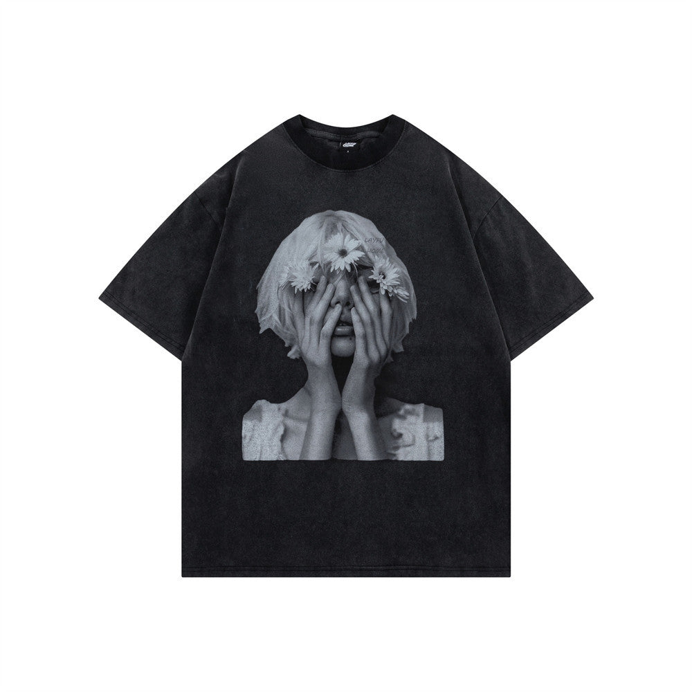 Oversized washed cotton graphic tee with black-and-white portrait print, shown in white and acid-washed black colorways