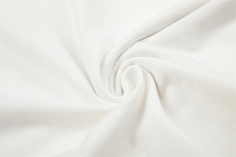 Close-up of white knit fabric texture with soft folded swirl