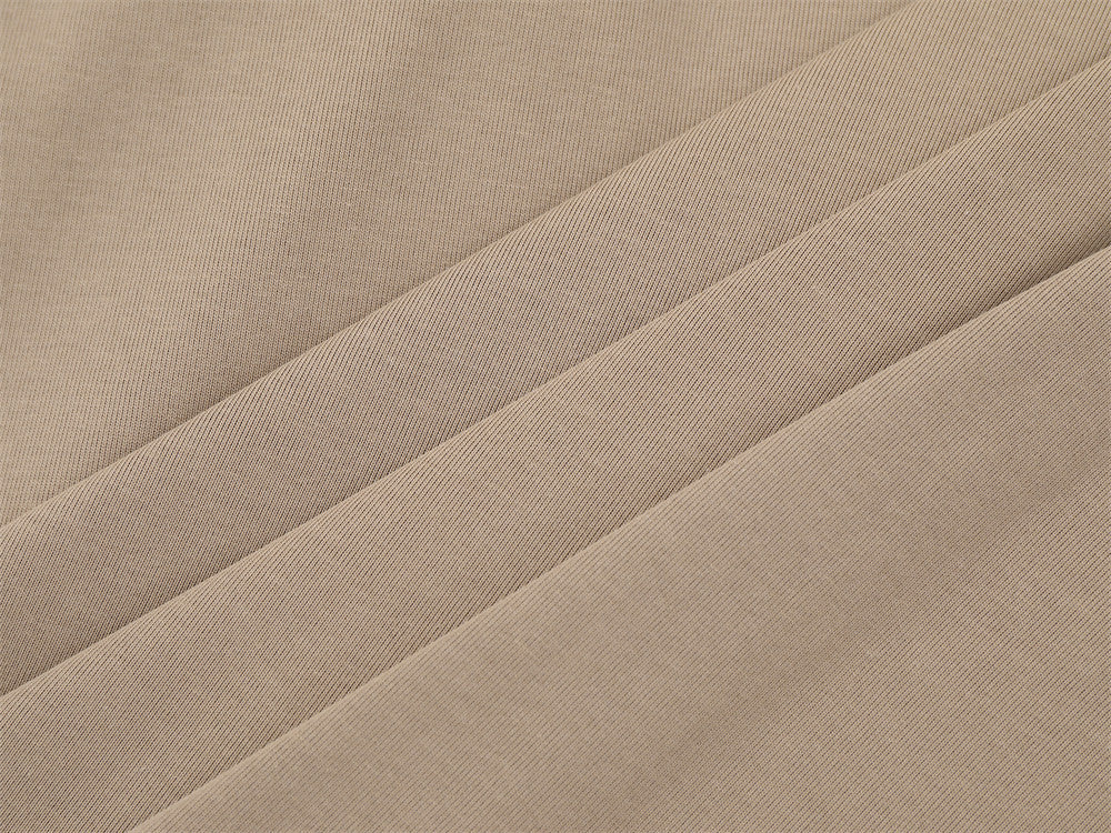 Close-up of khaki knit fabric with diagonal folds