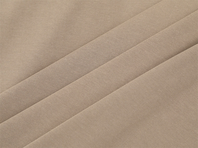 Close-up of khaki knit fabric with diagonal folds