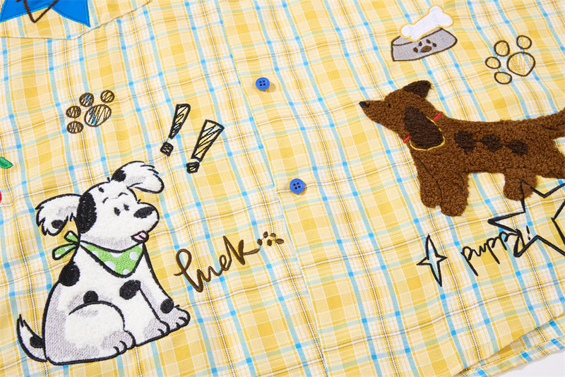Lower front of plaid shirt with seated dog embroidery and paw print details