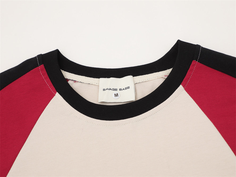 Close-up of crew neck collar and inside label on cream and red colorblock tee