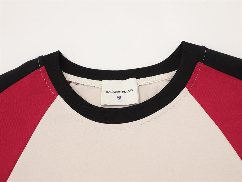 Close-up of crew neck collar and inside label on cream and red colorblock tee