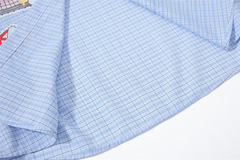 Blue plaid shirt fabric close-up near the side seam and hem