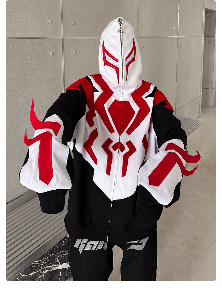 A person is wearing the Seakoff Superhero-Inspired Hoodie, a black, red, and white oversized streetwear sweatshirt featuring geometric designs on the front and sleeves. The fully zipped hood showcases an abstract symmetrical red pattern—perfect for comic book fans who love streetwear fashion.