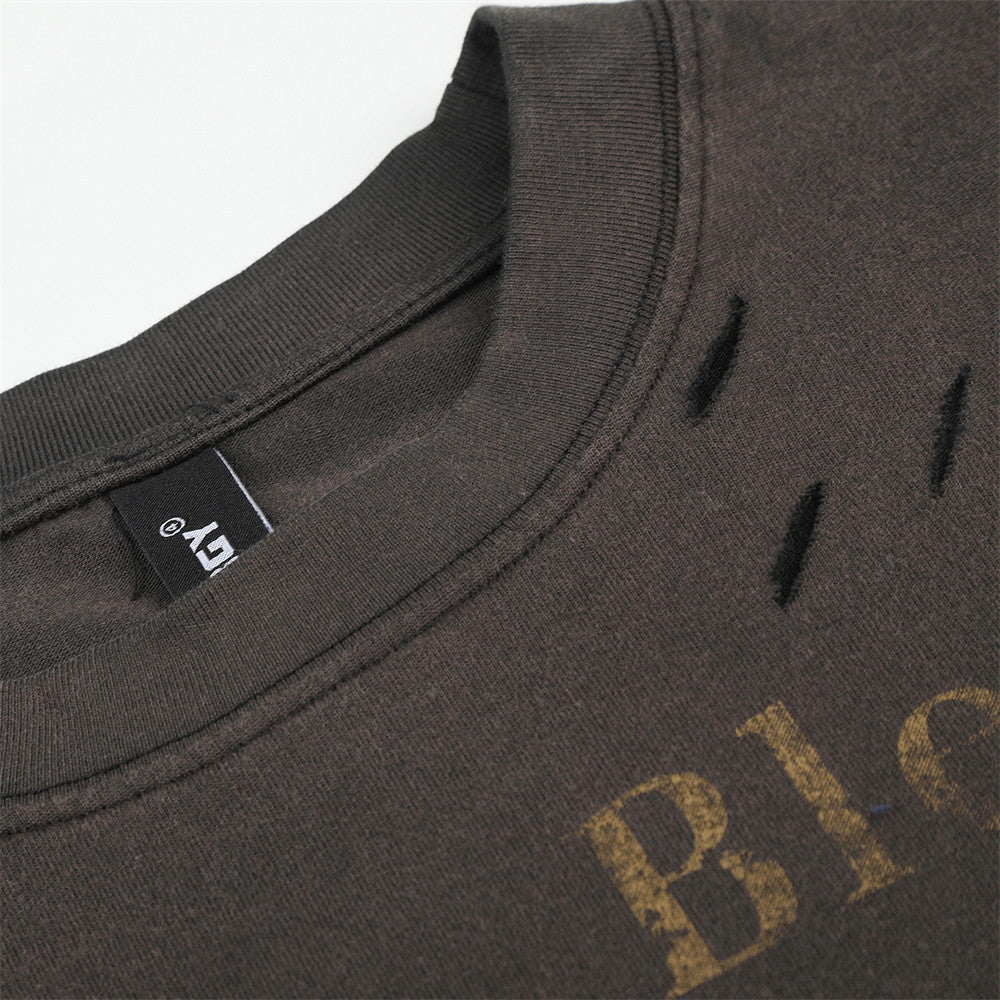 Close-up of neckline and shoulder area on black long sleeve T-shirt with distressed holes