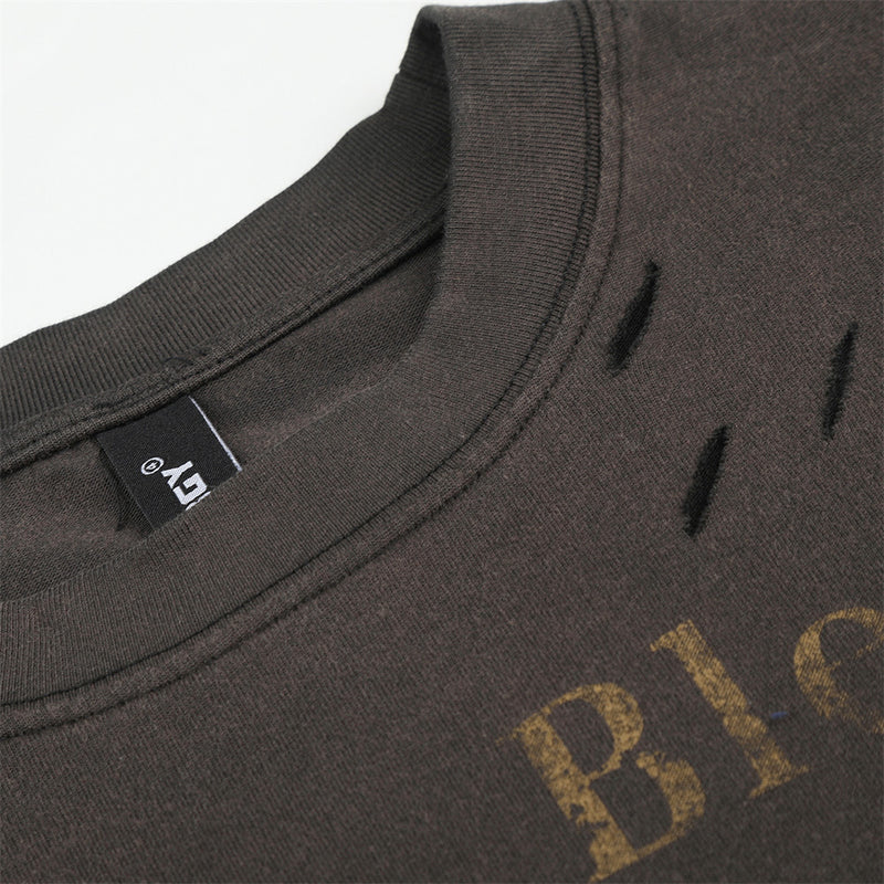 Close-up of neckline and shoulder area on black long sleeve T-shirt with distressed holes