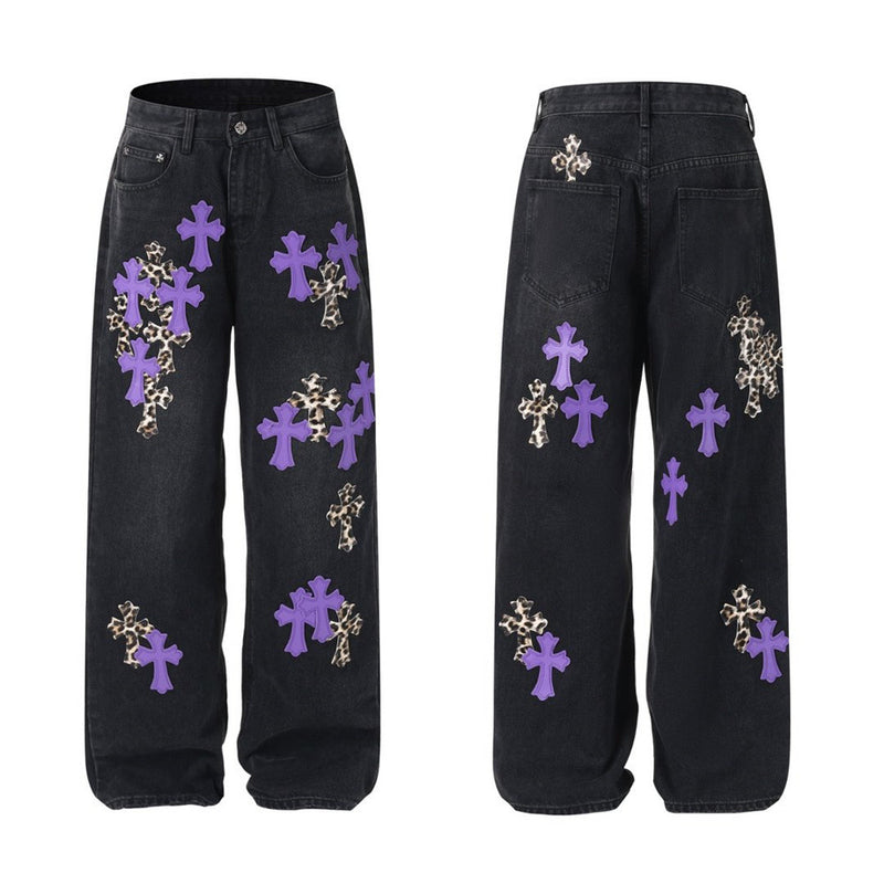 Men's baggy wide-leg jeans with oversized cross appliqué patches on washed black denim, front and back view