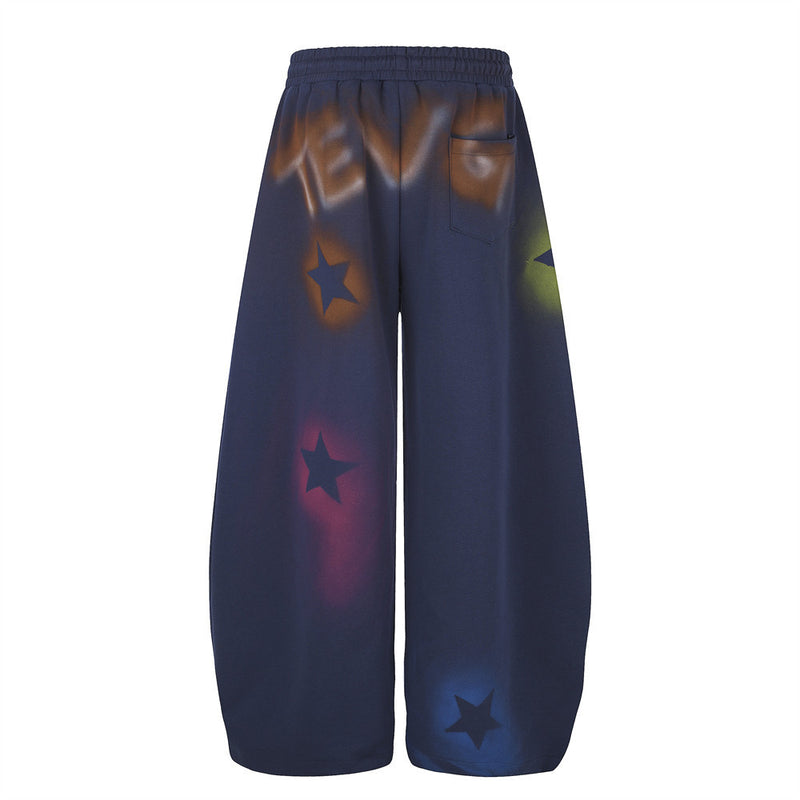 Navy wide leg sweatpants with star graffiti spray-dye shown back view with pocket