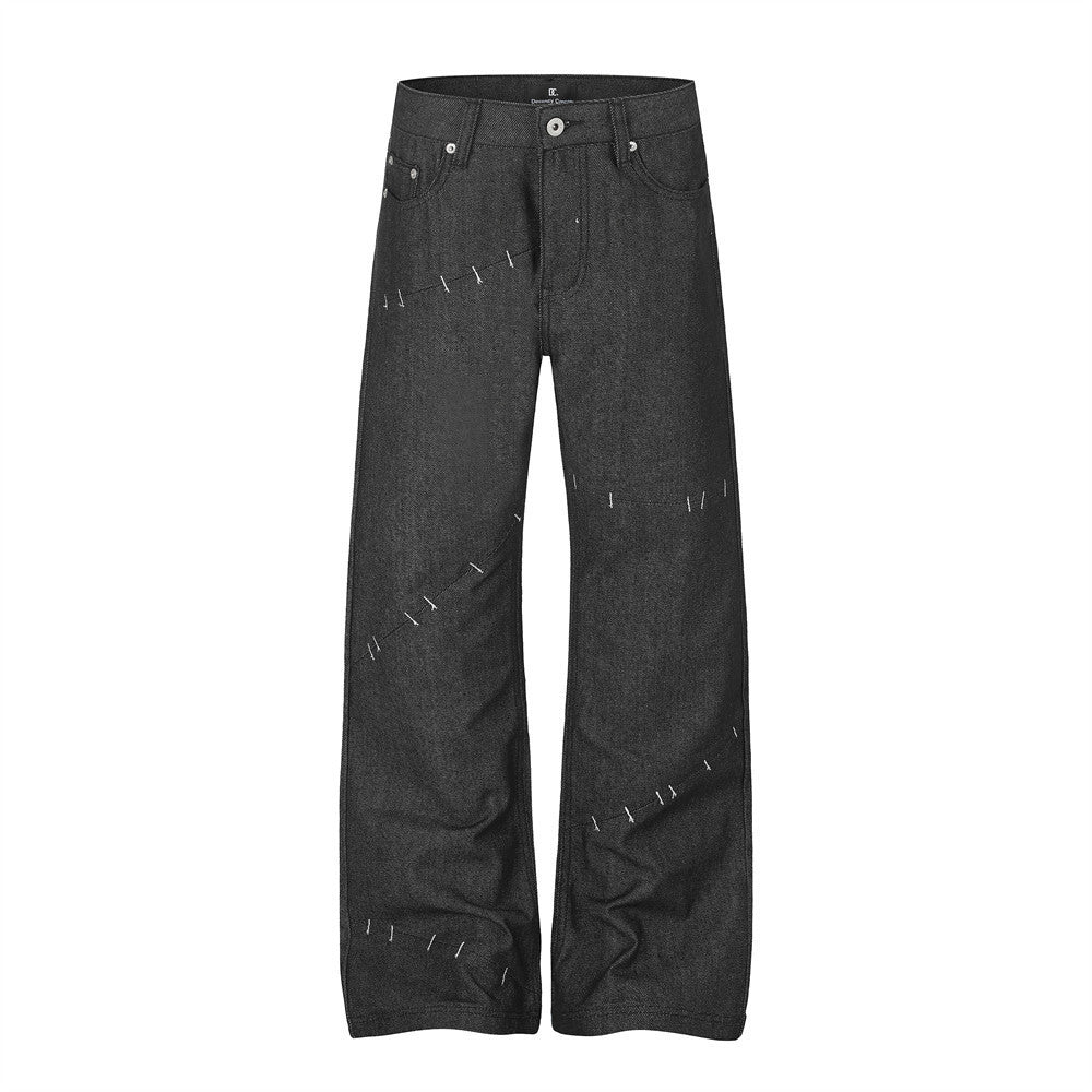 Men's dark charcoal wide-leg jeans with exposed contrast stitch detailing on front and back panels, straight silhouette