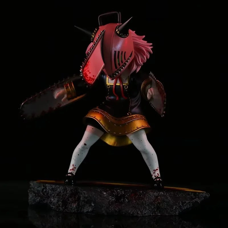 The Chainsaw Man Anya Forger PVC Figure by Spy × Family stands 17.5 cm tall, featuring a character with pink chainsaw helmet, long pink hair, on a textured black base. Dressed in a black outfit with gold trim and white leggings, while bloodstains accent the chainsaw blades—ideal for cosplay fans!.