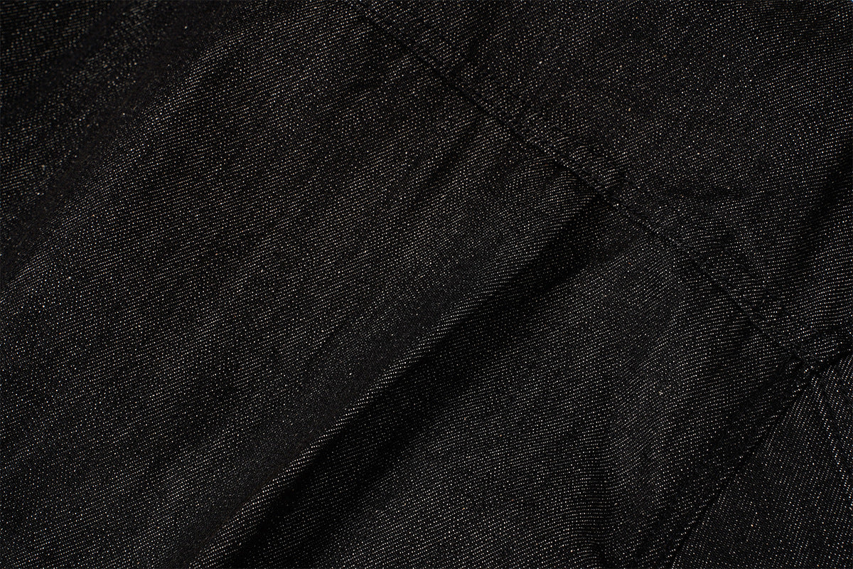 Veste en denim noir à devant plissé, fermetures à agrafes métalliques et clous turquoise