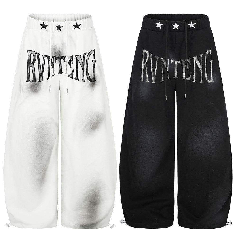 Pantalones de chándal holgados de pernera ancha con lavado efecto spray y gráfico de letras