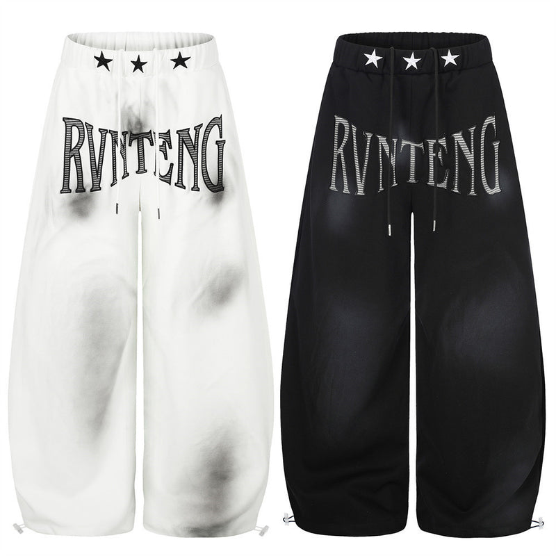 Pantalones de chándal holgados de pernera ancha con lavado efecto spray y gráfico de letras