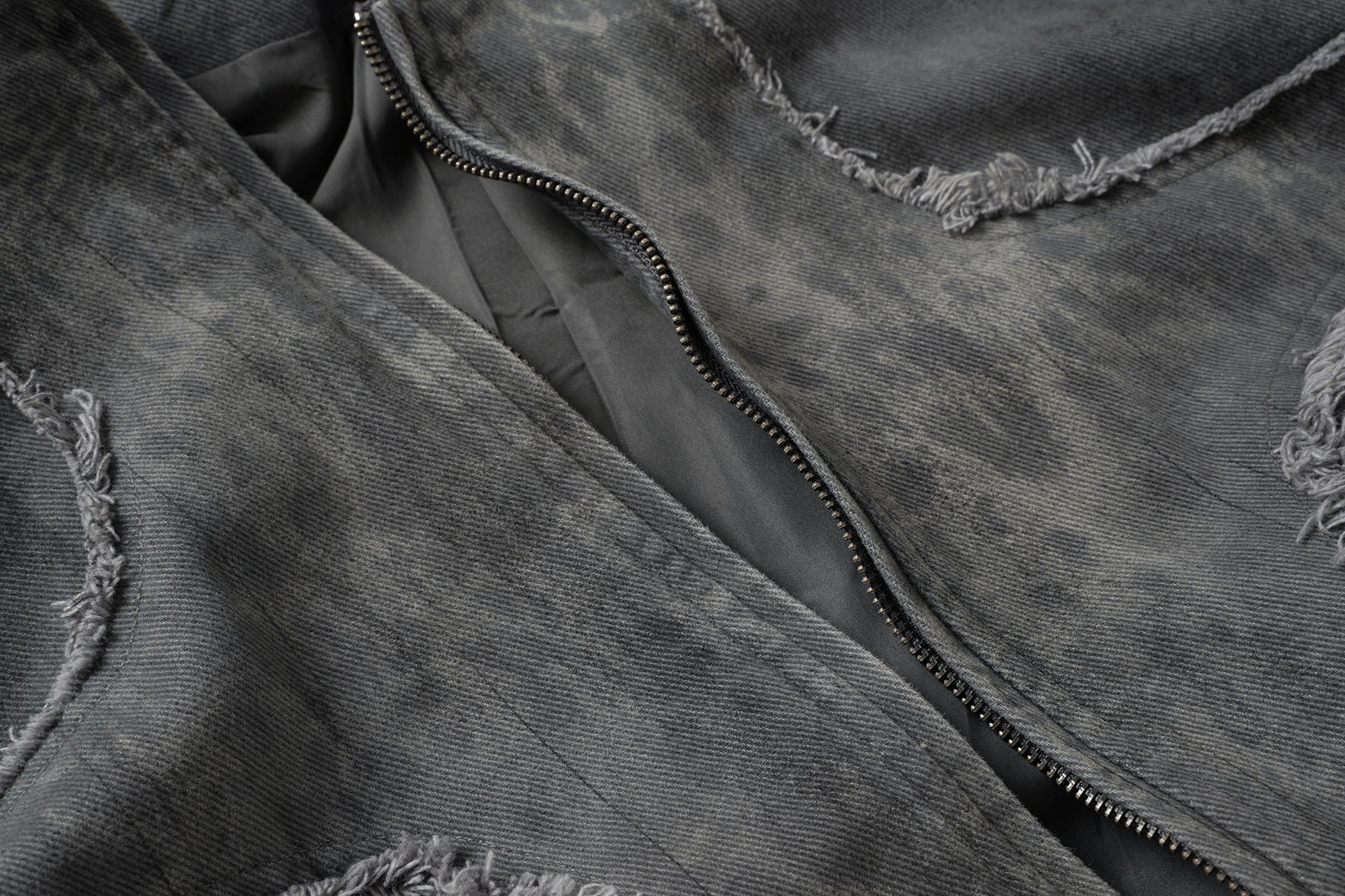 Veste bomber en jean délavé déconstruite à empiècement croisé et coutures effilochées