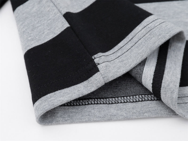 Close-up of hem and side seam on black and gray striped long sleeve shirt